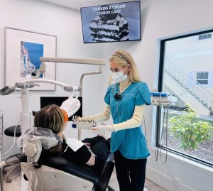 Dr. Cameron is with one of her patients, showing her the options for getting Zoom whitening
